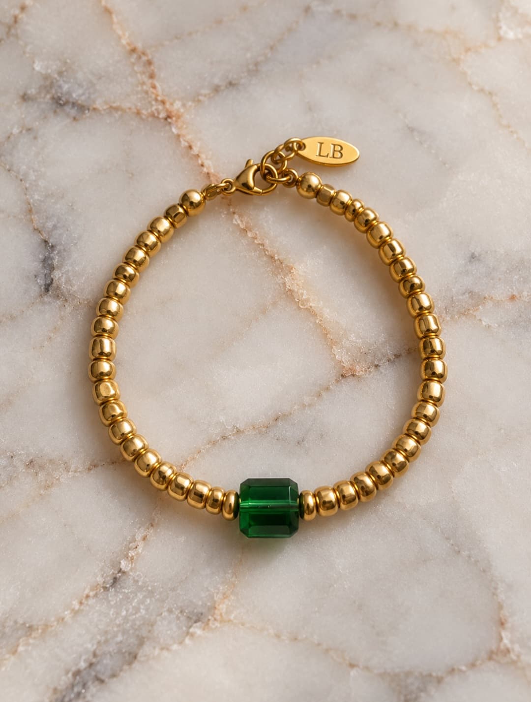 gold rocaille met groene facet